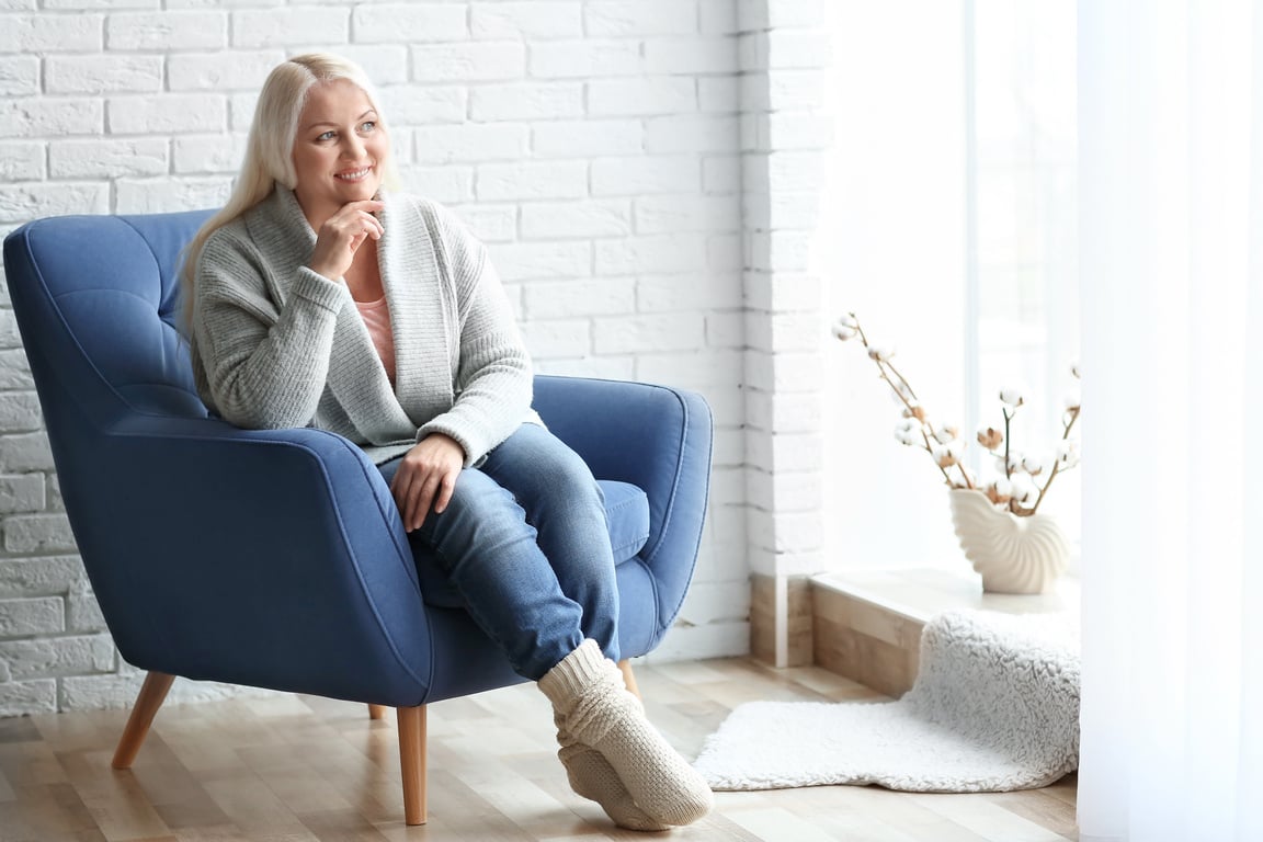 Senior Woman Relaxing on Armchair at Home