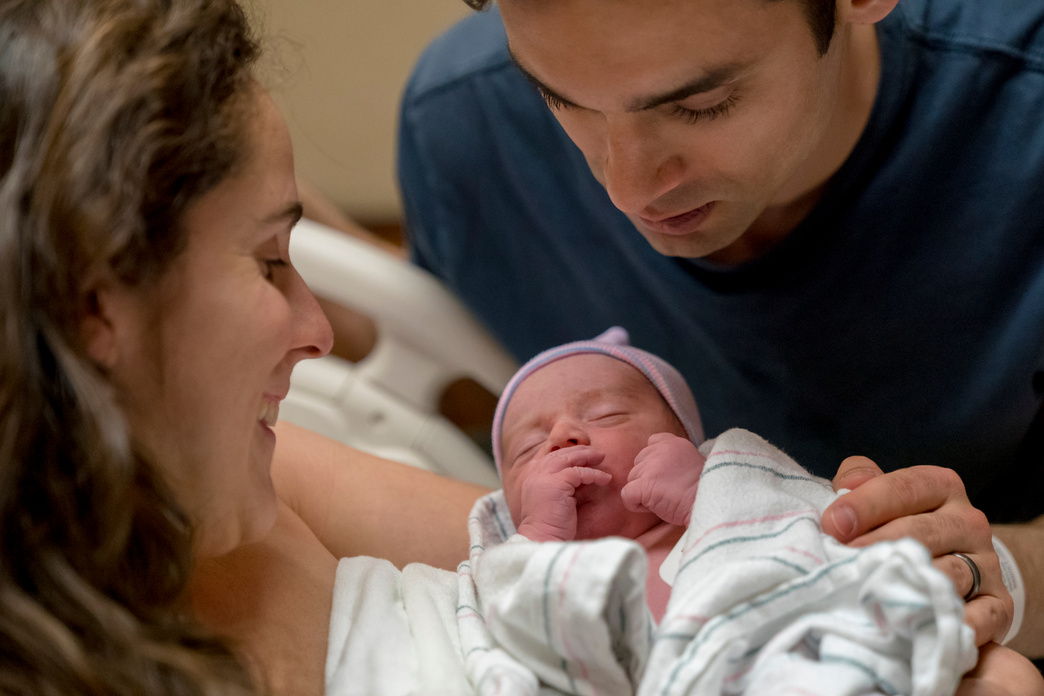 mom and dad with newborn boy in hospital